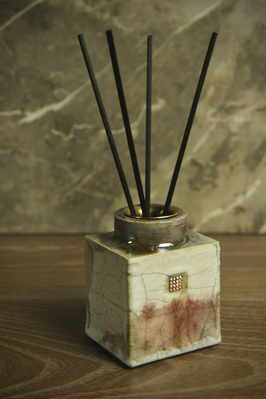 Ceramic reed diffuser on beige and brown color with stylish inserts